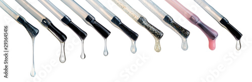 Lacquer drops at the tip of the brush. Different colored vicious liquid drops. Nail care technique, glitter and shimmer liquids. Beautiful transparent blobs isolated on white