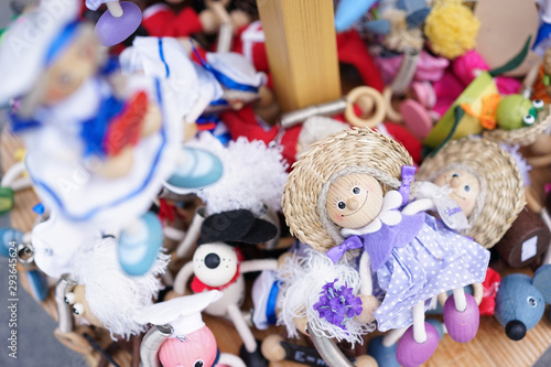 Common souvenirs of animal toys. Wooden animal toys of a little girl and other animals. Soft focus on the girl in purple dress. These toys are general souvenirs from the Postojna cave.