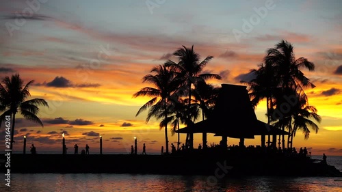 Silhouettes of people and coconut tree during sunset in Kota Kinabalu, Sabah Borneo, Malaysia.  photo