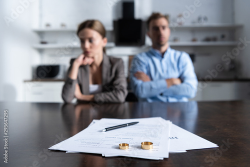selective focus of couple sitting at table with divorce documents photo