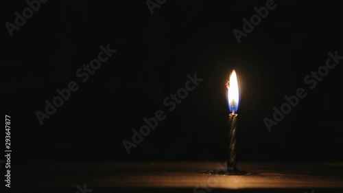 Burning candle timelapse on a black background.