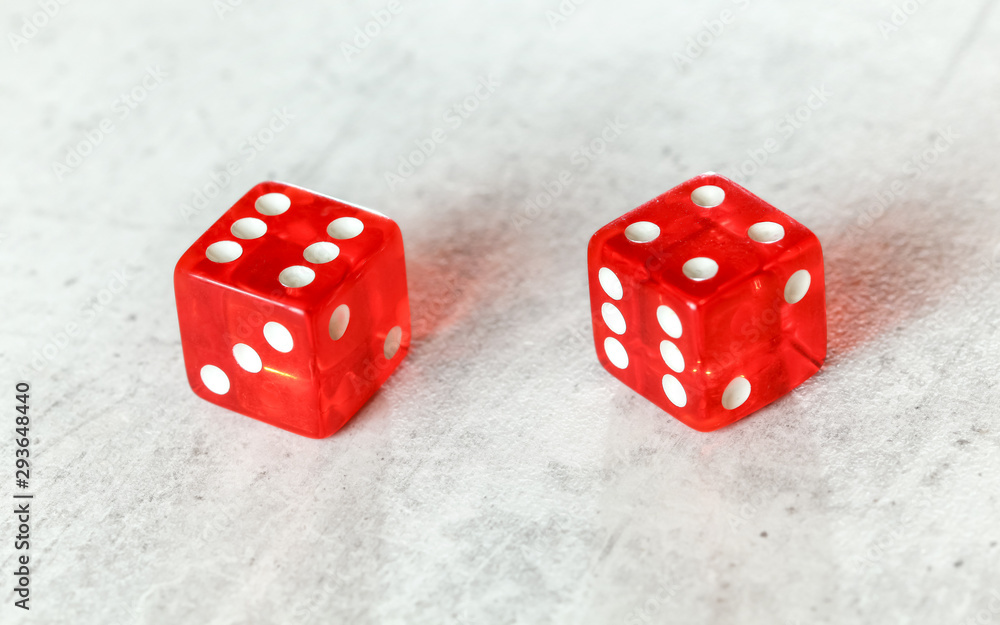 Two translucent red craps dices on white board showing Easy Ten (number 6 and 4) Two translucent red craps dices on white board showing Easy Ten (number 6 and 4)