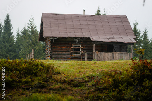 Old house in the mountains. Fog. Dawn. Gicha mountain meadow. Carpathians