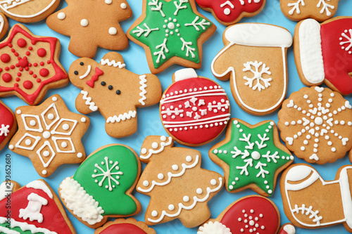 Flat lay composition with tasty homemade Christmas cookies on light blue background