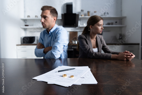 selective focus of couple sitting at table with divorce documents photo