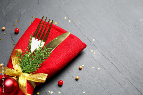 Cutlery set on grey textured table, space for text. Christmas celebration © New Africa