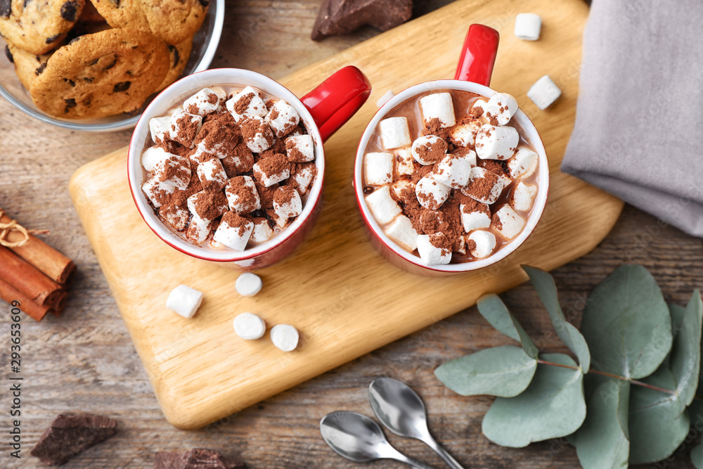 Flat lay composition of tasty cocoa with marshmallows on wooden table Flat lay composition of tasty cocoa with marshmallows on wooden table