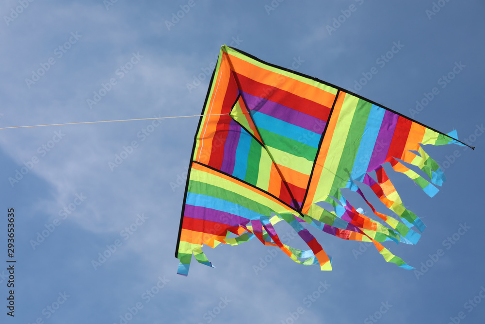 big kite with vivid colors on blue sky