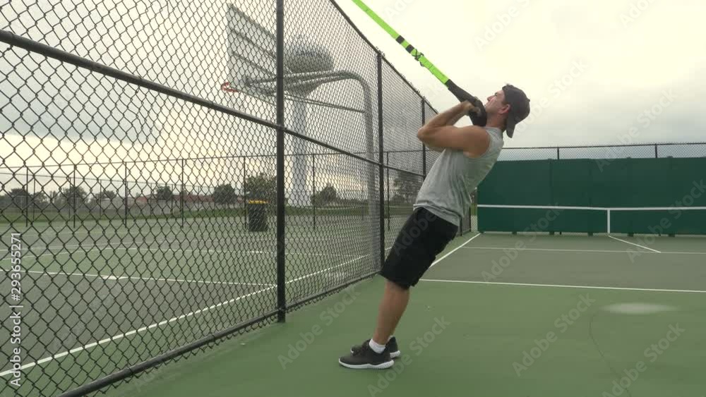 In shape man exercising, training, working out, doing suspension trainer biceps curls, body weight exercises, outdoors, 60fps. In shape man exercising, training, working out, doing suspension trainer biceps curls, body weight exercises, outdoors, 60fps.