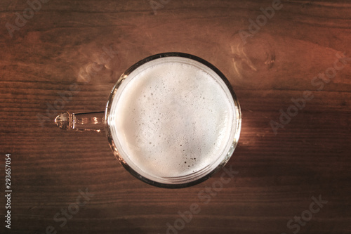 top view of glass of beer on rustic table, it is one of the oldest and most widely consumed alcoholic drinks in the world
