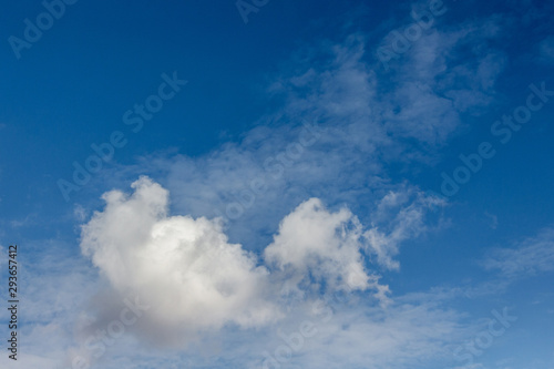 White curly clouds of various shapes in the blue sky_
