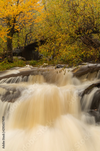 Miller Creek Waterfall and Footbridge In Autumn