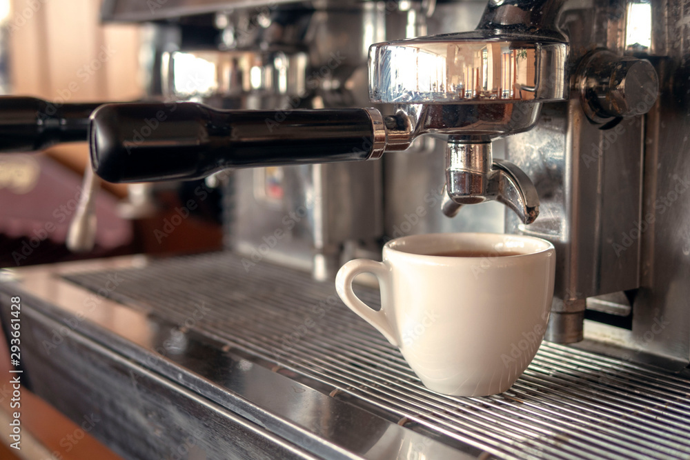 Cup of coffee under the nozzle of a coffee machine Cup of coffee under the nozzle of a coffee machine