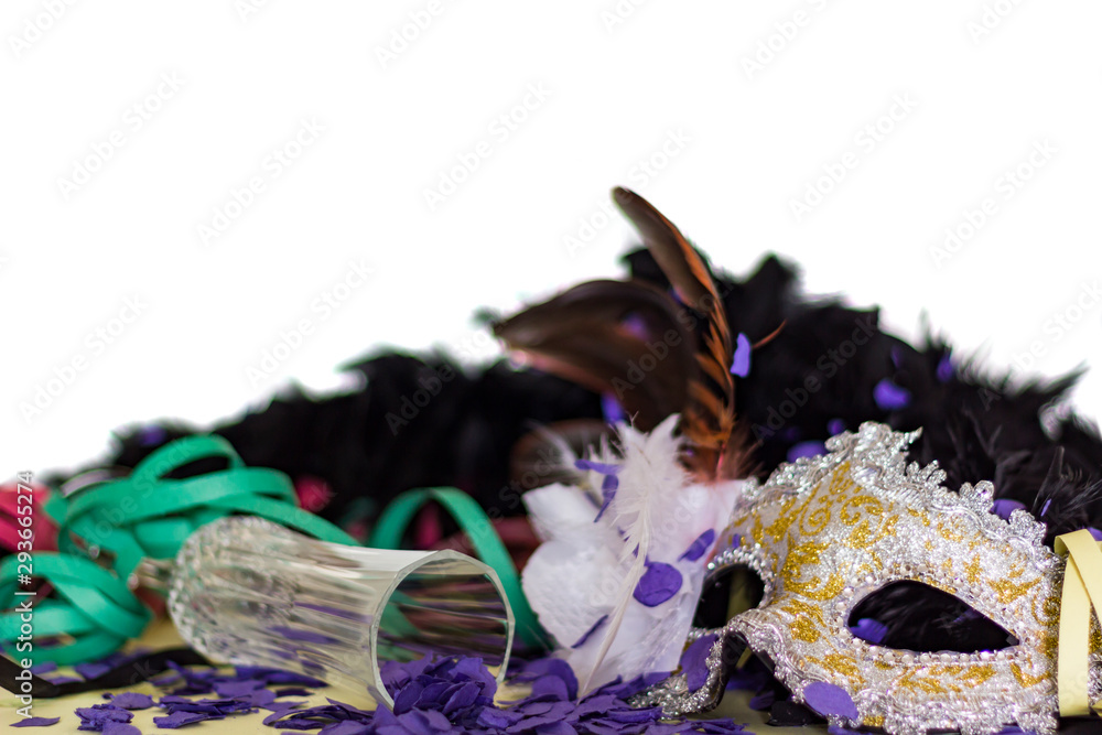 Celebration and Party concept. Carnival Mask, Serpentines, Confetti and champagne glass agains white background