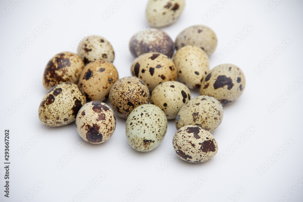 Quail eggs on grey background.