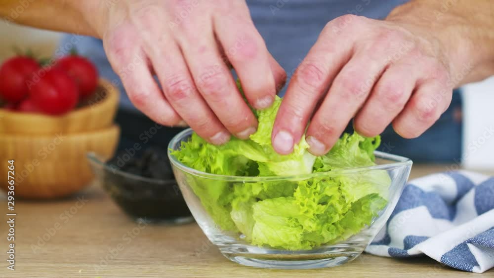 Mans hans preparing fresh vegetable salad in his kitchen. Slow motion video shot on Black Magic Cinema camera 6K on RAW format Mans hans preparing fresh vegetable salad in his kitchen. Slow motion video shot on Black Magic Cinema camera 6K on RAW format