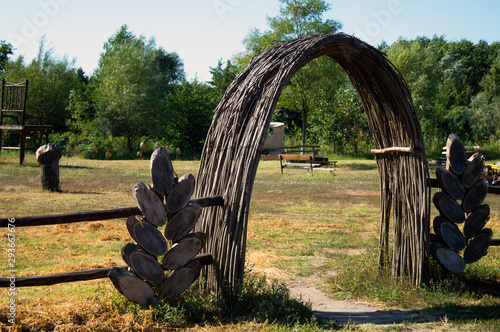 Ukrainian traditional willow gate into the park in countryside 