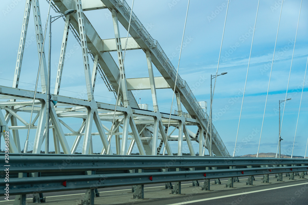 White arches of new Crimean Bridge, also called Kerch Bridge, through Kerch Strait to Crimea. Automobile and railway bridge connecting Taman and Kerch. White arches of new Crimean Bridge, also called Kerch Bridge, through Kerch Strait to Crimea. Automobile and railway bridge connecting Taman and Kerch.
