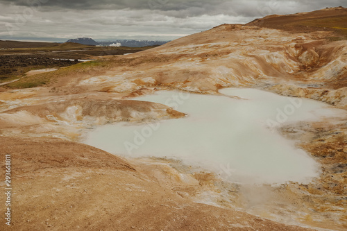 Leirhnjukur, Krafla fires in Iceland, blue water on clay hill, overcast day in summer, film effect with grain