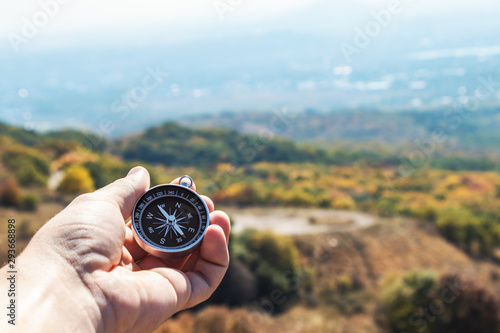 Compass in hand, in the mountains, autumn.