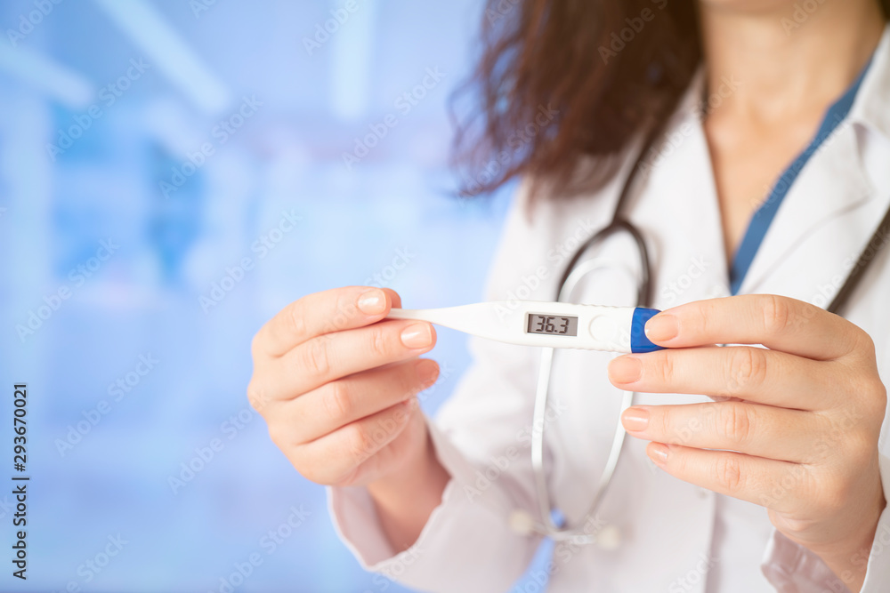 Young doctor woman holding thermometer Young doctor woman holding thermometer