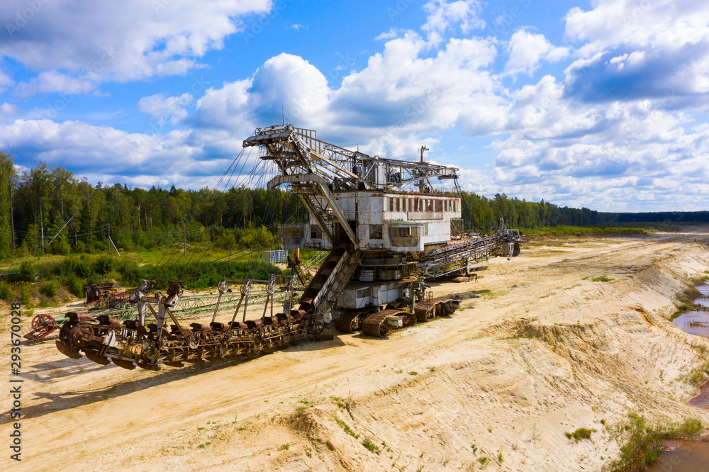 Fototapeta premium old rusty multi bucket excavator, giant stacker, absetzer in sandy career