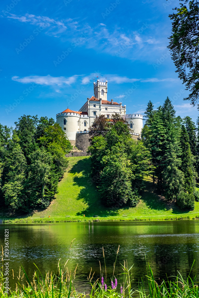 - Old castle of Trakoscan on lake and green hill in Zagorje, Croatia on sunny summer day