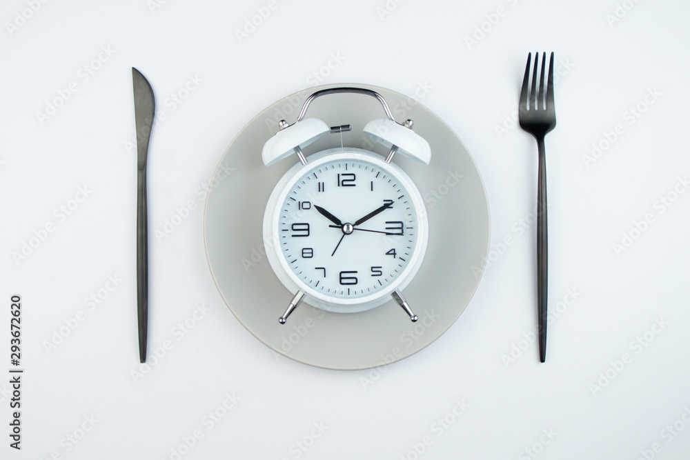 White alarm clock on gray plate. Top veiw. White alarm clock on gray plate. Top veiw.