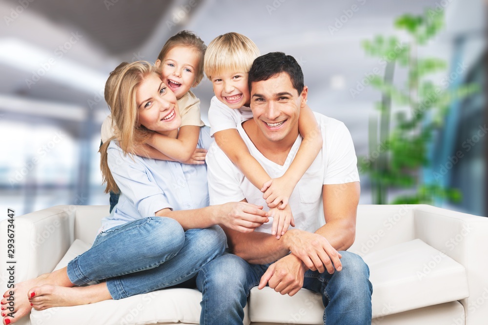 Young  family at home smiling at camera