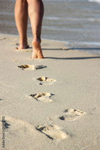 footprints of women on the sandy beach