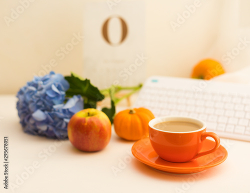 Cup Of Fresh Coffee Latte Is On The Working Desk With Decorations Inspired by Autumn. Creative Still Life Composition. Orange Is The Color Of Season. Blurred Background, Copy Space.