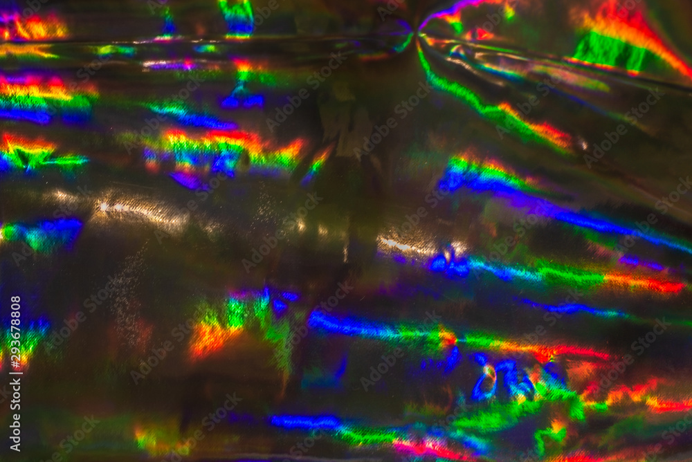 Fototapeta premium Tło holograficzne. Streszczenie błyszczące wesołe tapety. Wesoła świąteczna folia disco. Holograficzny rozmyty efekt świetlny bokeh.