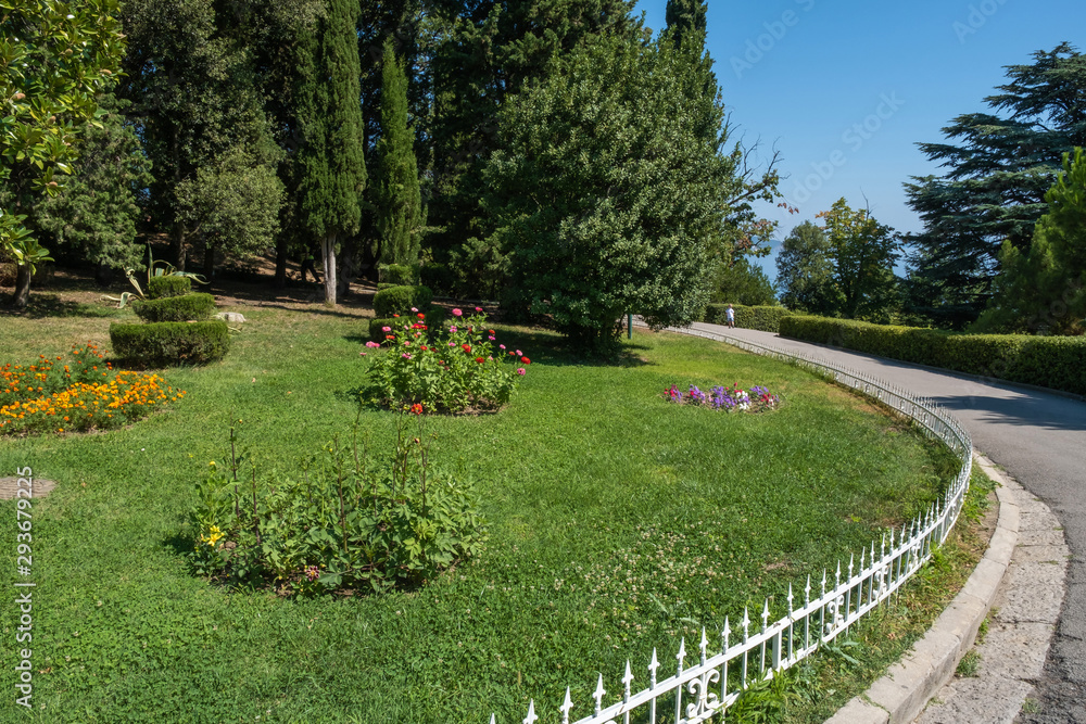 Well-kept lawn with flower beds in Livadia Park, Crimea.