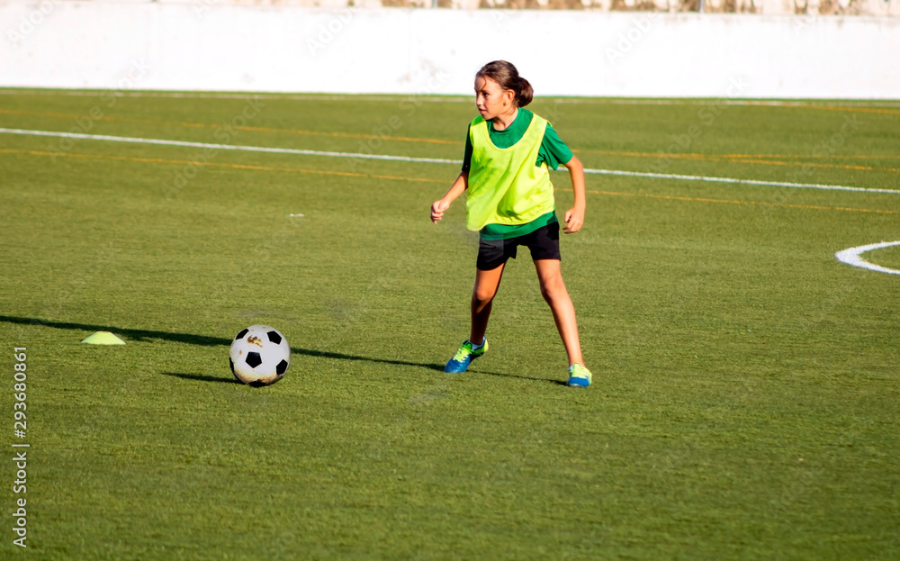 Little girl in a soccer training