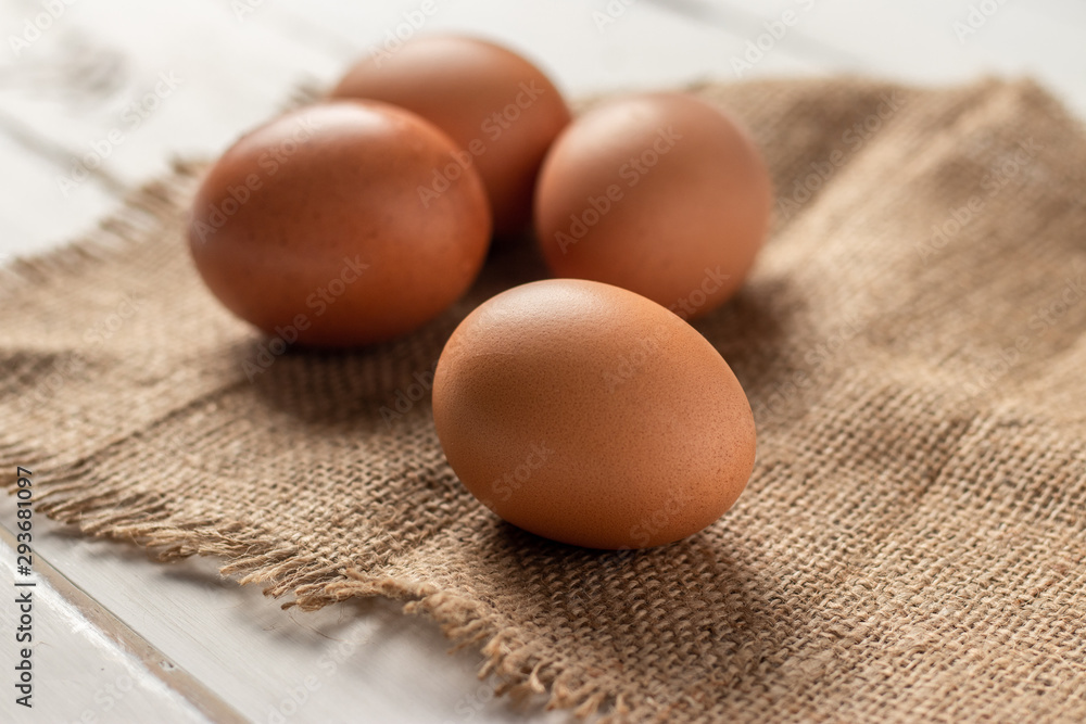 Fresh farm brown eggs over a rustic wood table Fresh farm brown eggs over a rustic wood table