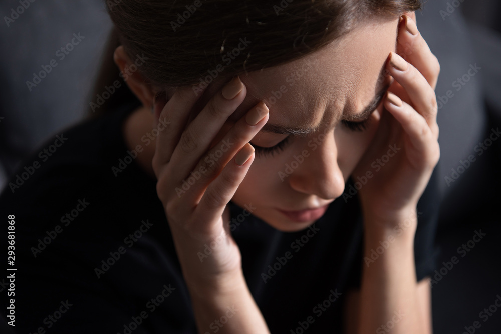 upset young woman touching face with closed eyes at home upset young woman touching face with closed eyes at home