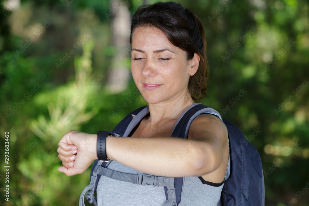 female hiker looking at connectivity watch female hiker looking at connectivity watch