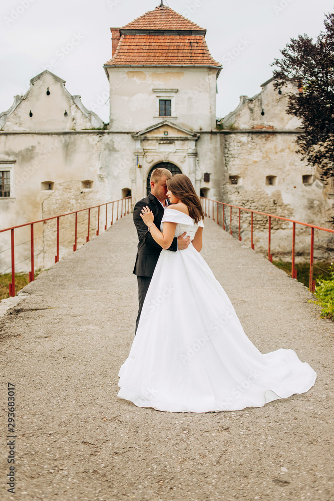 Young couple hugging each others on old castle background