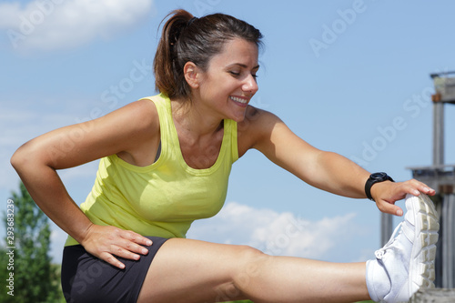 sporty female stretching in the park