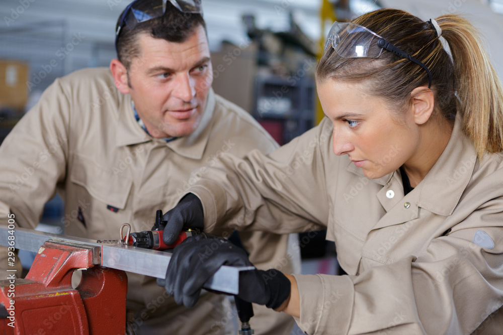 industrial female apprentice working with supervisor industrial female apprentice working with supervisor