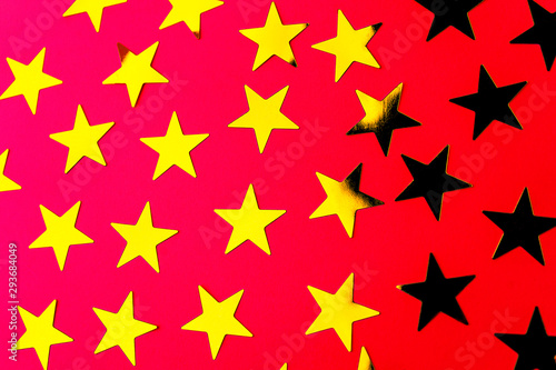 Bunch of gold stars on red background.