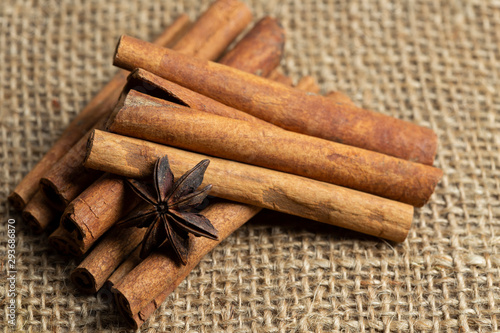cinnamon sticks and star anise on burlap background