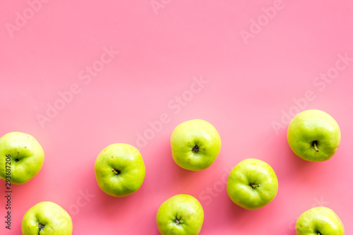 Green apples pattern on pink background top view frame copy space