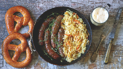 Banner. Oktoberfest food. Bavarian sausages and sauerkraut in a pan. Fresh Bavarian beer food. Oktoberfest celebration. Selective focus. Macro.
