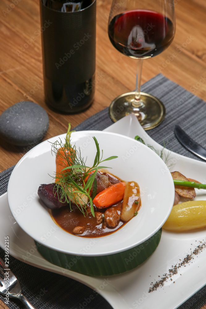 Slow-cooked pork filet in a white wine demi-glace sauce. Exquisite dish. Creative restaurant meal concept.