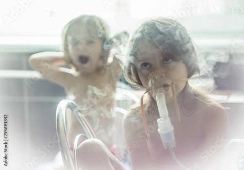 Sick girl breathes with a nebulizer