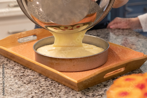 Εκτύπωση καμβά Cake batter being poured out of a silver bowl into a round cake pan