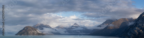 Beautiful Panoramic View of American Mountain Landscape on the Ocean Coast during a cloudy and colorful morning in fall season. Taken in Glacier Bay National Park and Preserve, Alaska, USA.