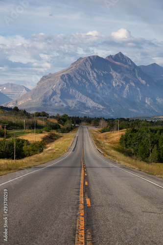 Beautiful View of Scenic Highway with American Rocky Mountain Landscape in the background during a Cloudy Summer Morning. Taken in St Mary, Montana, United States. © edb3_16