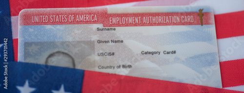Employment Authorization card on USA Flag surface. Close up view. Wide photo
